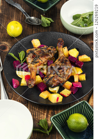 Duck legs marinated in pineapple and slices dragon fruit. 126269219