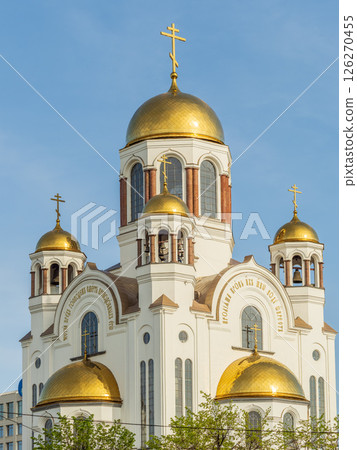 The golden domes of the Christian church in sunset light. 126270455