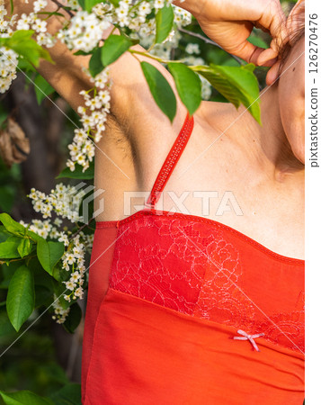 Closeup of long dark hair growing under arm of young female. Concept of hygiene, natural beauty, feminity and body hair growth 126270476