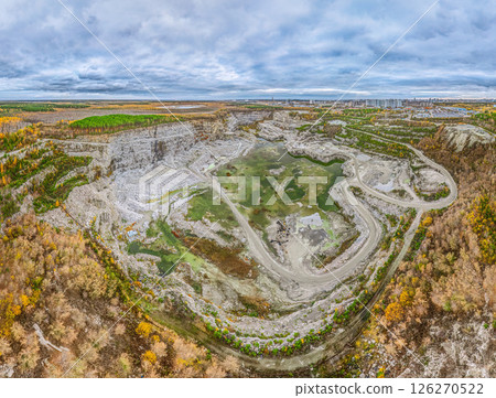 Stone quarry in the forest. Flying over the autumn mixed forest during sunset. The surroundings of Yekaterinburg. Ural, Russia, Aerial View Stone quarry in the forest. Flying over the autumn mixed forest during sunset. The surroundings of Yekaterinburg. Ural, Russia, Aerial View 126270522