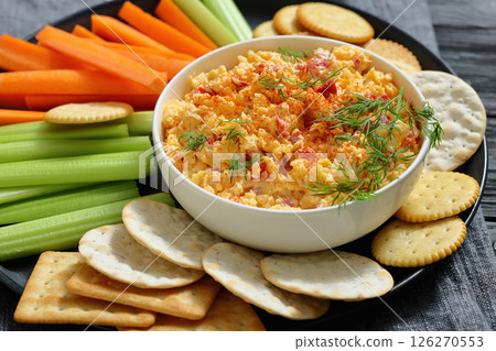 pimento cheese dip served with crackers, veggies 126270553