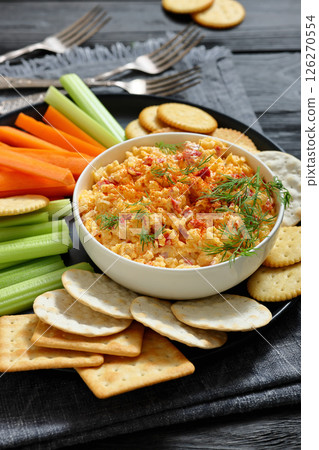 pimento cheese dip served with crackers, veggies 126270554