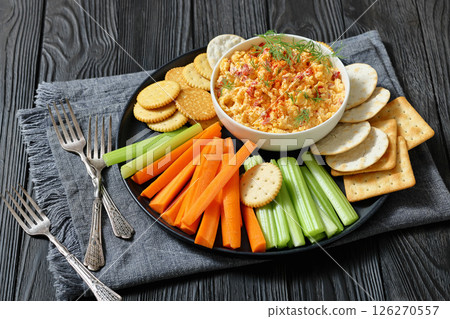 pimento cheese dip served with crackers, veggies 126270557
