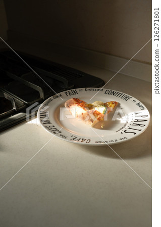 Pizza on a plate in the kitchen Pizza on a plate in the kitchen 126271801