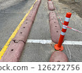The curbs are overlapped with flexible orange traffic milestone and tape 126272756