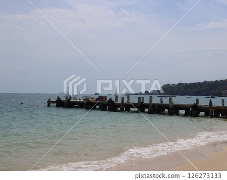 The Serene Beach Pier is at a beautiful sandy shore, ideal for recreation and relaxation The Serene Beach Pier is at a beautiful sandy shore, ideal for recreation and relaxation 126273133