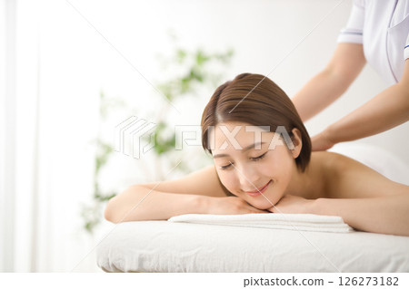 A woman in her twenties receiving a massage at a beauty salon A woman in her twenties receiving a massage at a beauty salon 126273182