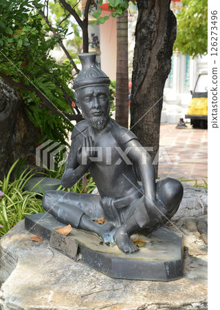 Statue of a hermit performing a massage therapy pose at Wat Phra Chetuphon Wimon Mangkhalaram or Wat Pho. This place is most famous for Thai massage. Located at Bangkok capital city in Thailand. 126273496