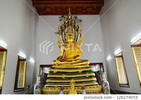 Buddha Sheltered by Naga Hood Buddha statue posture is enshrined in the western sanctuary in Wat Phra Chetuphon Wimonmangklaram or Wat Pho is popular with both tourists. Buddha Sheltered by Naga Hood Buddha statue posture is enshrined in the western sanctuary in Wat Phra Chetuphon Wimonmangklaram or Wat Pho is popular with both tourists. 126274058