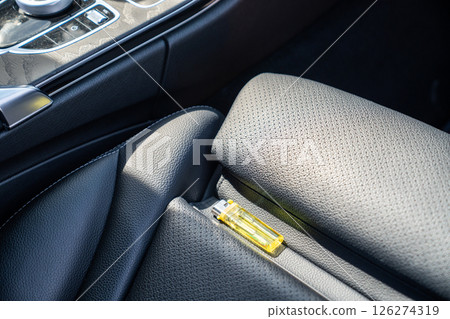 Lighter in car on hot sunny day. High temperatures in summer can cause explosions and fires 126274319