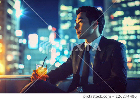 asian businessman in suit sitting on the street at night 126274496