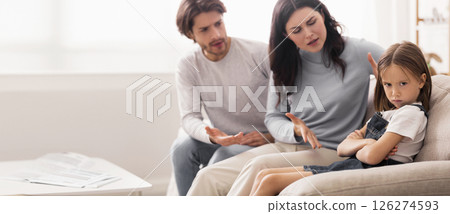 Naughty Kid. Annoyed Parents Scolding Their Little Daughter For Her Behaviour While Sitting Together On Couch At Home Naughty Kid. Annoyed Parents Scolding Their Little Daughter For Her Behaviour While Sitting Together On Couch At Home 126274593