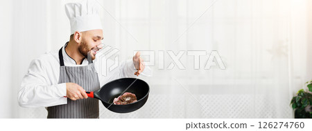Cooking Meat. Chef Man Holding Pan With Fresh Roast Beef Steak Standing In Restaurant Kitchen Indoor. Cooking Meat. Chef Man Holding Pan With Fresh Roast Beef Steak Standing In Restaurant Kitchen Indoor. 126274760