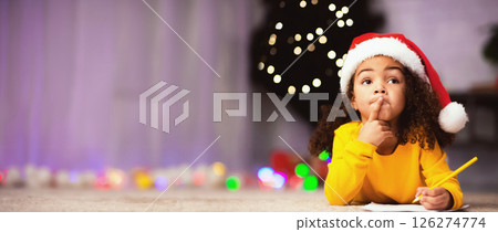What do I want. Pensive little black girl thinking what to ask from Santa Claus, free space 126274774