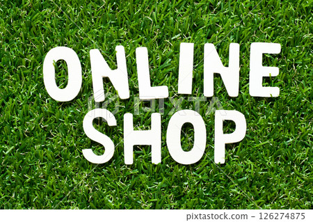 Wood alphabet letter in word online shop on green grass background Wood alphabet letter in word online shop on green grass background 126274875