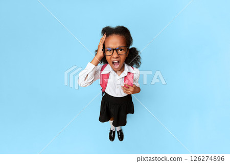 Back To School Stress. Afro Girl Shouting Touching Head Looking At Camera On Yellow Background. High-Angle Studio Shot 126274896