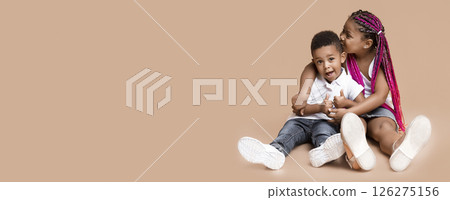Sister is my best friend. Portrait of adorable african american siblings sitting on floor and cuddling, little boy showing thumbs up, copy space 126275156