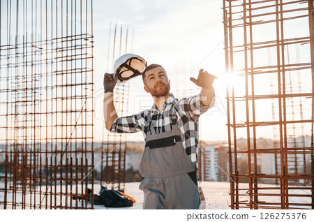 Throwing the hard hat. Man is working on the construction site at daytime 126275376