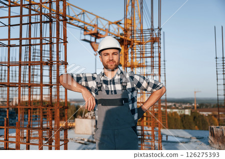 Front view of man that is working on the construction site at daytime Front view of man that is working on the construction site at daytime 126275393
