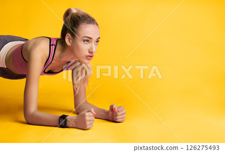 Fitness Workout. Motivated Woman Doing Plank Exercise Over Pink Background. Studio Shot, Copy Space Fitness Workout. Motivated Woman Doing Plank Exercise Over Pink Background. Studio Shot, Copy Space 126275493
