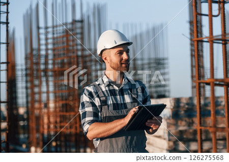 Man is working on the construction site at daytime 126275568