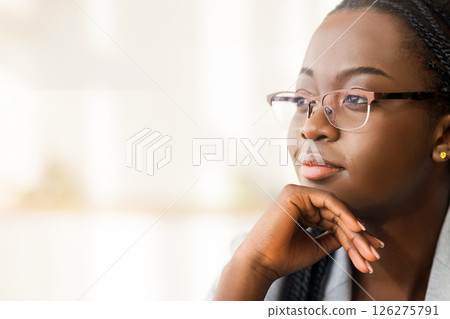 Closeup portrait of confident african american businesswoman in glasses looking aside with ambitious face expression, copy space 126275791