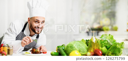 Chef Man Cooking Chicken Decorating Dish With Herbs Plating Dinner Standing In Kitchen Indoor. Selective Focus 126275799