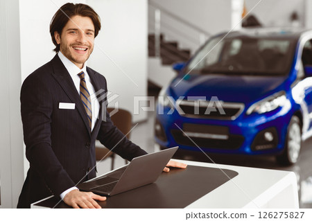 Successful Dealer. Car Sales Manager Standing At Desk In Luxury Dealership Office, Looking At Camera, Copyspace Successful Dealer. Car Sales Manager Standing At Desk In Luxury Dealership Office, Looking At Camera, Copyspace 126275827
