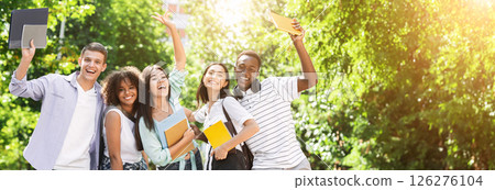 Portrait of joyful college students posing outdoors after passing exam, celebrating success and sincerely laughing, copy space 126276104