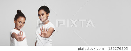 Beautiful african teenaged girls showing no sign over grey studio background 126276205