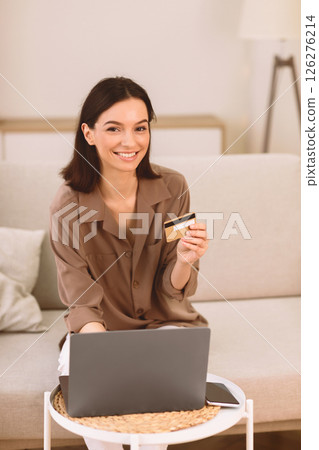 Online Shopping. Happy Girl Using Laptop And Credit Card Buying Things From Home, Looking At Camera, Copyspace Online Shopping. Happy Girl Using Laptop And Credit Card Buying Things From Home, Looking At Camera, Copyspace 126276214