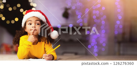Christmas wish. Thoughtful little african american girl thinking what to ask from Santa Claus, empty space 126276360