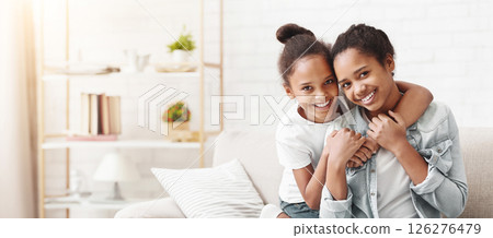 Happy sisterhood. Cute african american girls embracing at home, copy space 126276479