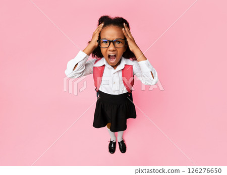 Stressed Black Schoolgirl Shouting Touching Head Standing In Studio On Yellow Background. High-Angle, Vertical Shot 126276650