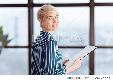 Documents For Business. Smiling Lady Holding Folder With Papers Standing In Modern Office. Selective Focus Documents For Business. Smiling Lady Holding Folder With Papers Standing In Modern Office. Selective Focus 126276661