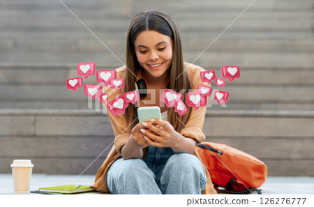 A young woman sits on steps, smiling as she checks her smartphone. Above her, pink hearts and notifications appear, indicating social media activity. Her backpack sits beside her 126276777