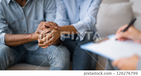 Couples Therapy Concept. Unrecognizable Black Man And Woman Holding Hands At Marital Psychologist's Office. Cropped, Selective Focus 126276799