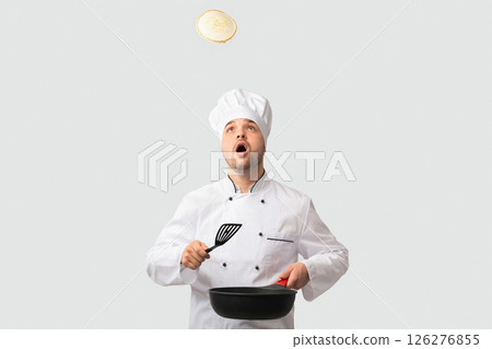 Cooking Food. Surprised Chef Man Holding Pan And Spatula Looking Up Standing Over White Background. Studio Shot 126276855