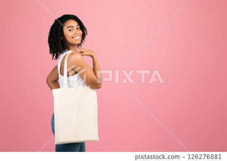 African Girl With Canvas Bag On Isolated White Studio Background. Eco bag mockup, empty space 126276881