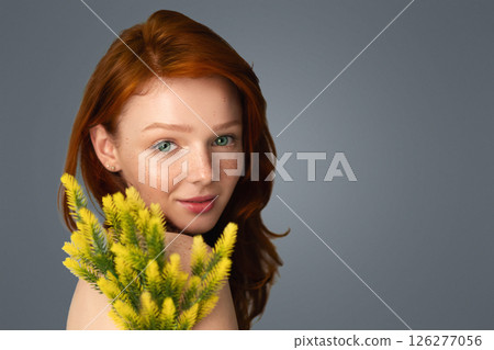 Ginger-Haired Young Female Posing With Plant On Gray Background In Studio. Panorama With Blank Space For Advertisement Text. Female Beauty Portrait Concept 126277056