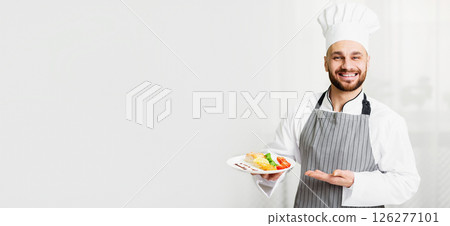 Fish Recipes. Cheerful Chef Man Holding Plate With Roasted Salmon Steak Serving Dish Standing In Kitchen. Selective Focus Fish Recipes. Cheerful Chef Man Holding Plate With Roasted Salmon Steak Serving Dish Standing In Kitchen. Selective Focus 126277101