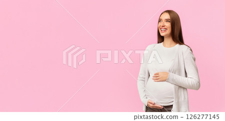 Motherhood. Happy Pregnant Lady Touching Belly Standing Over White Background. Studio Shot, Free Space 126277145