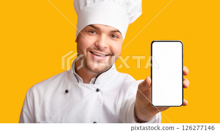Food Delivery App. Chef Man Showing Phone With Blank Screen Recommending Catering Service Standing On Yellow Studio Background. Panorama Food Delivery App. Chef Man Showing Phone With Blank Screen Recommending Catering Service Standing On Yellow Studio Background. Panorama 126277146