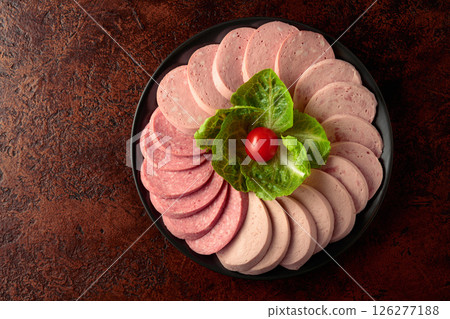 Various boiled sausages on a brown vintage background. 126277188