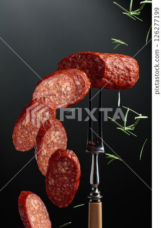 Sliced chorizo on a fork. 126277199