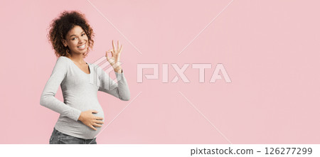 Everything is okay. Excited afro woman showing ok sign over pink background 126277299