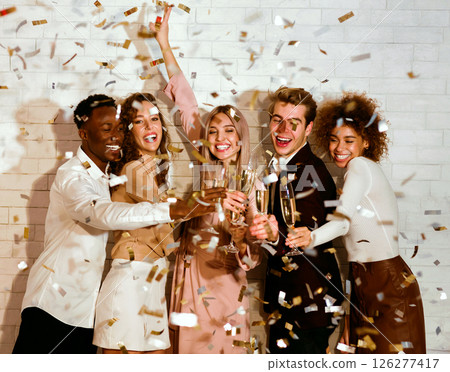 Party Concept. Diverse Guys And Girls Clinking Glasses Under Falling Confetti Celebrating Holiday Indoor. 126277417