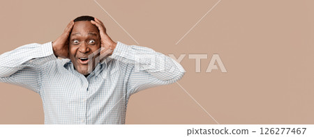 Unbelievable. Portrait of excited mature african man holding his head in fully happiness. Unbelievable. Portrait of excited mature african man holding his head in fully happiness. 126277467