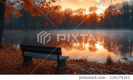Golden leaves surround a peaceful lake as a bench sits empty, inviting solitude. The sunset casts warm hues, creating a tranquil atmosphere. Golden leaves surround a peaceful lake as a bench sits empty, inviting solitude. The sunset casts warm hues, creating a tranquil atmosphere. 126278161