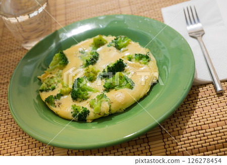 Wholesome breakfast. omelet with broccoli on green plate Wholesome breakfast. omelet with broccoli on green plate 126278454